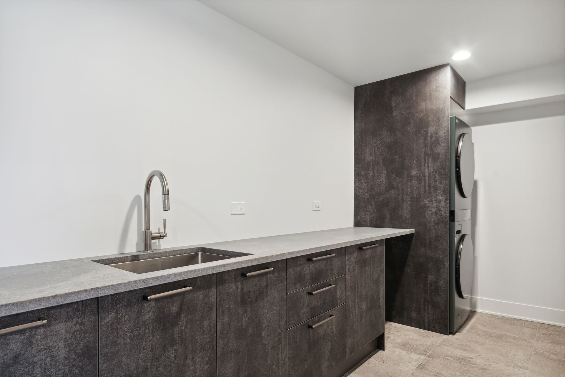 A kitchen with a sink and a refrigerator in it