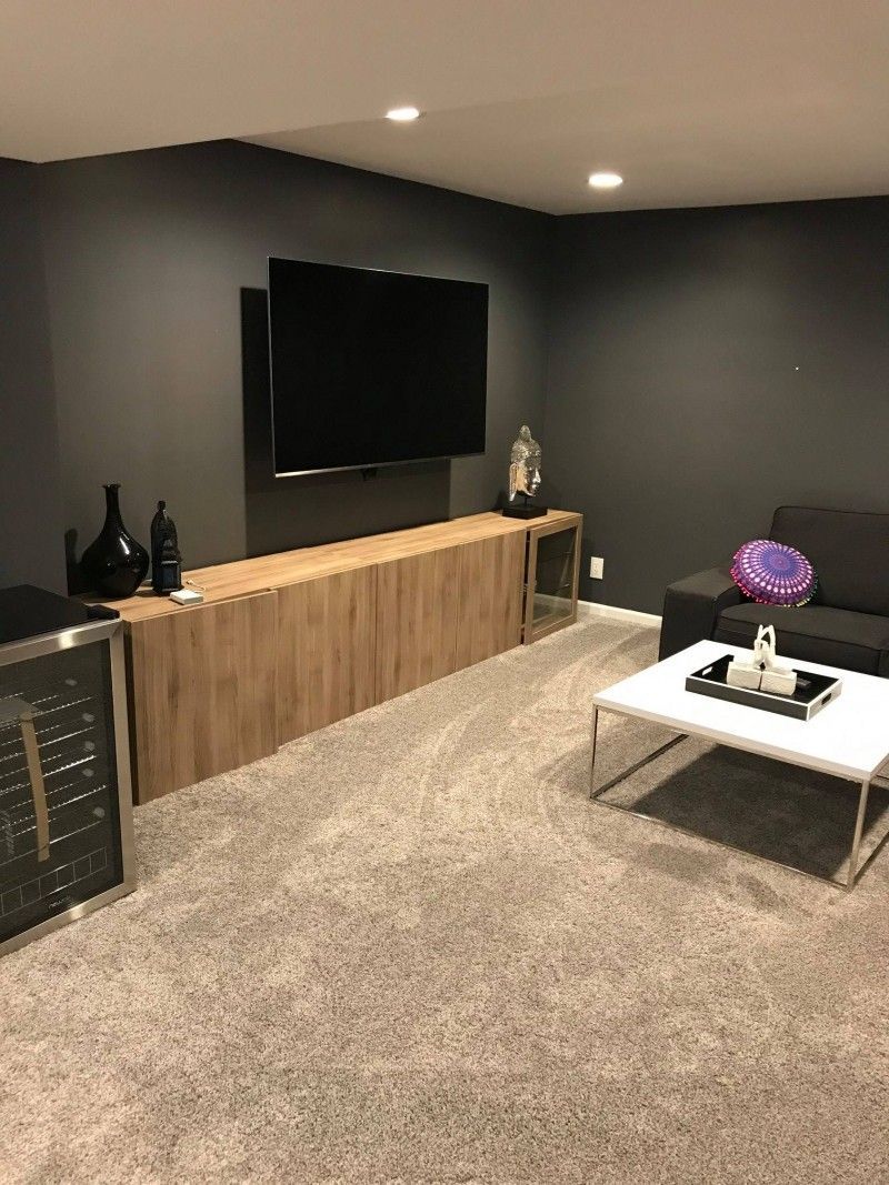 A living room with a couch , coffee table , and television.