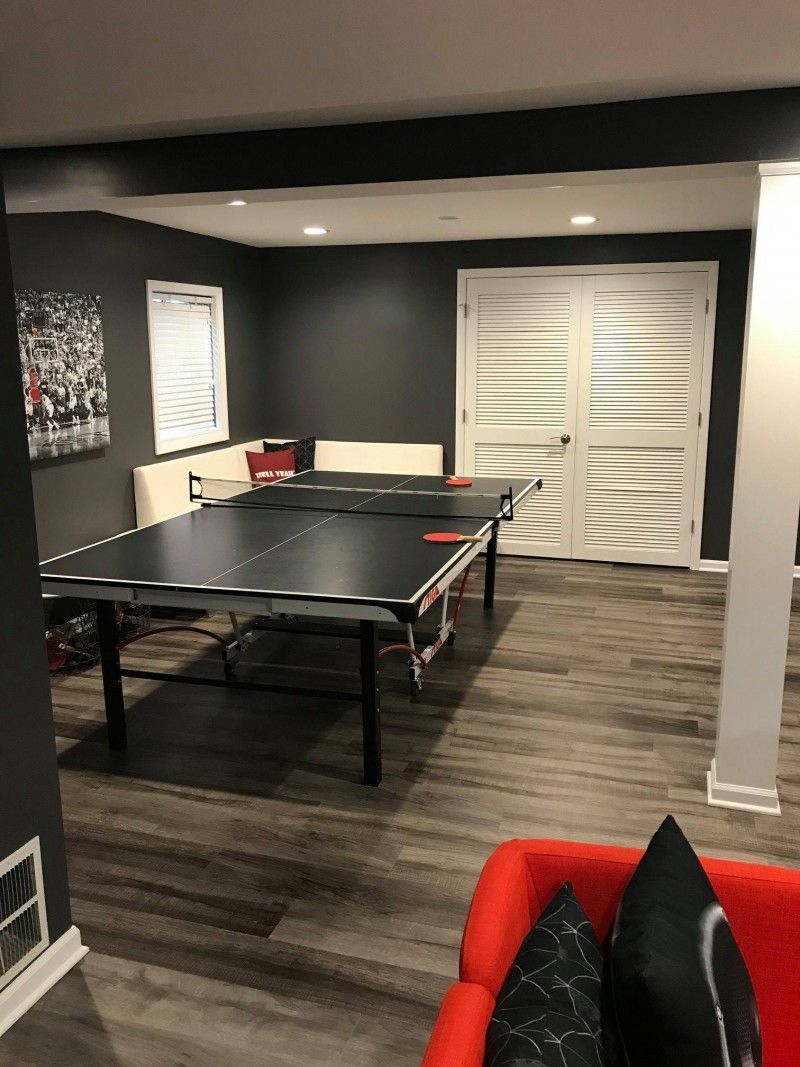 There is a ping pong table in the middle of the room.