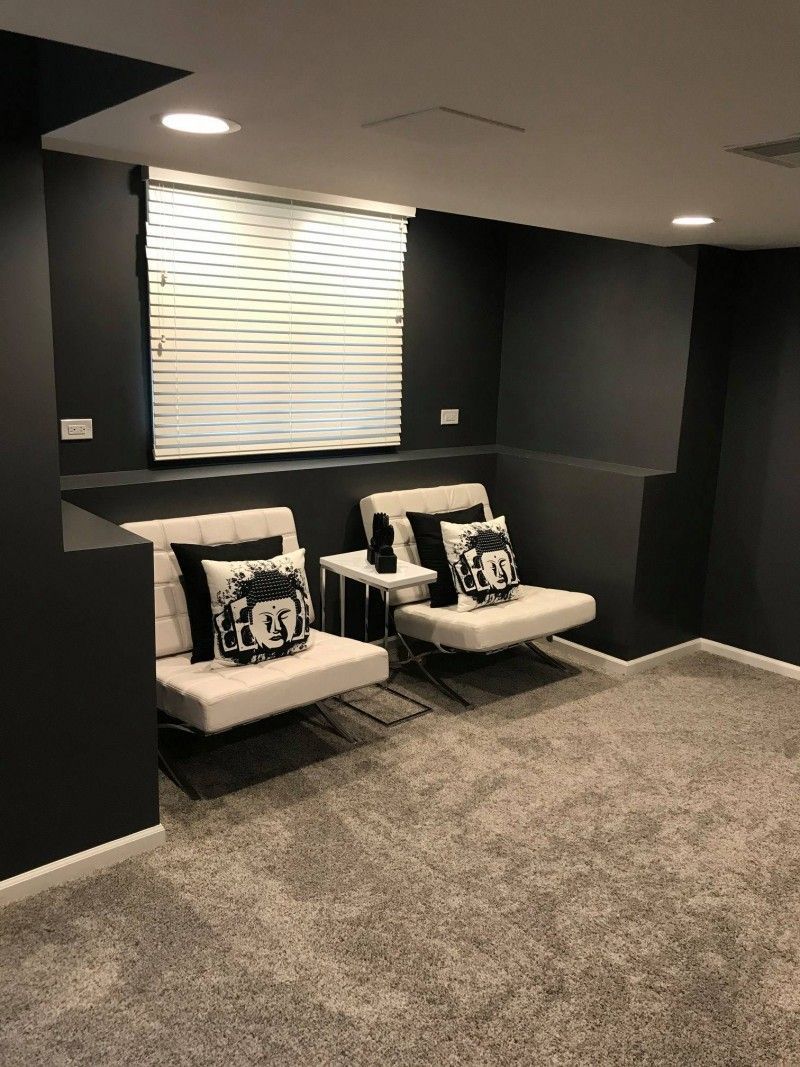 A living room with two chairs and a window.