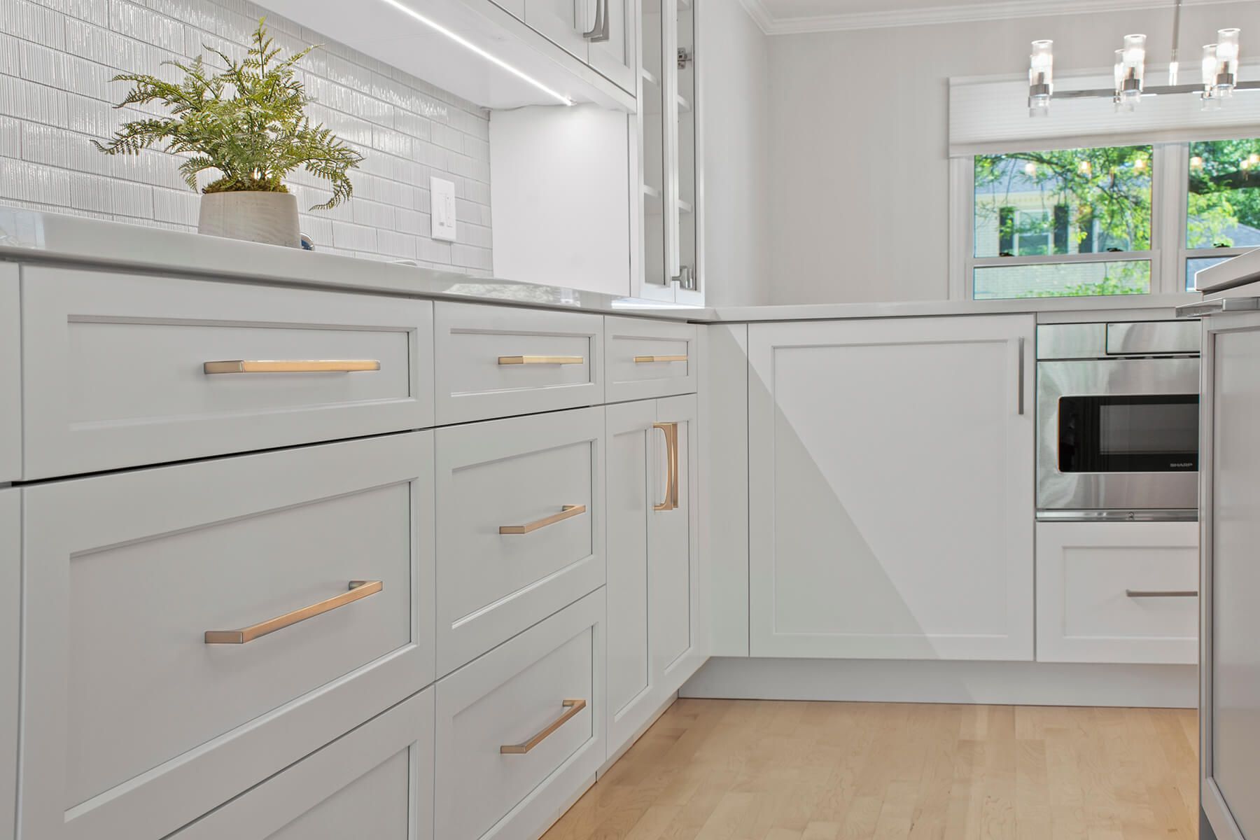 A kitchen with white cabinets and stainless steel appliances.