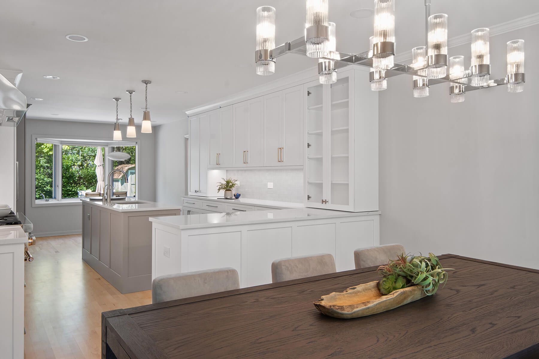 A dining room table with a bowl of food on it in a kitchen.