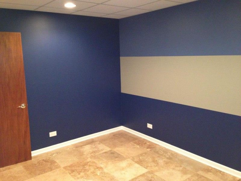 A room with blue walls and a white board on the wall