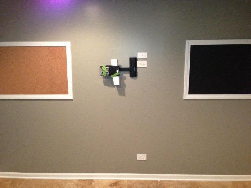 A cork board and a blackboard are hanging on a wall