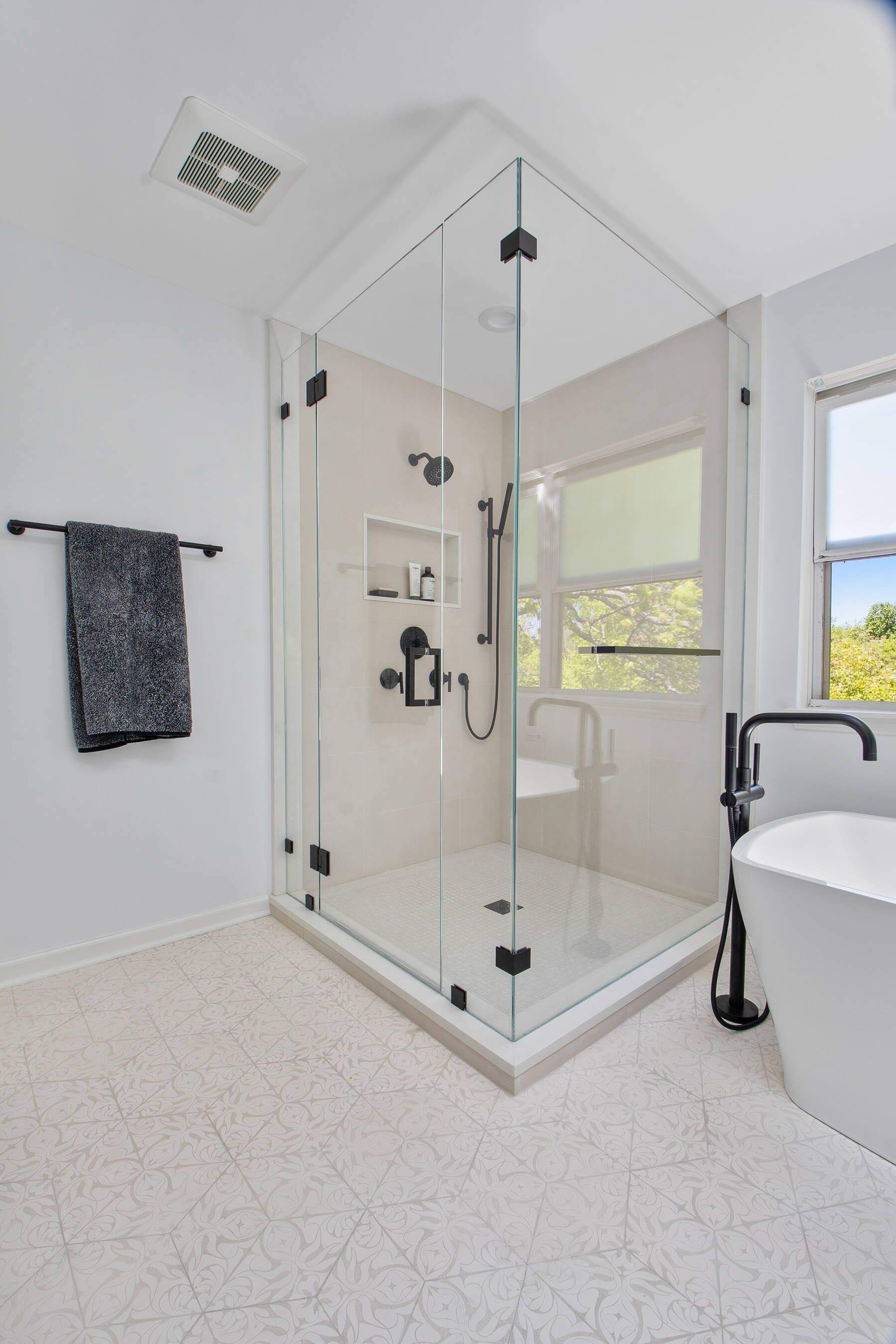 A bathroom with a walk in shower and a bathtub.
