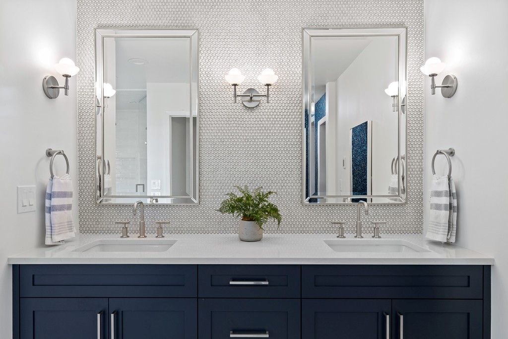 A bathroom with two sinks and two mirrors.