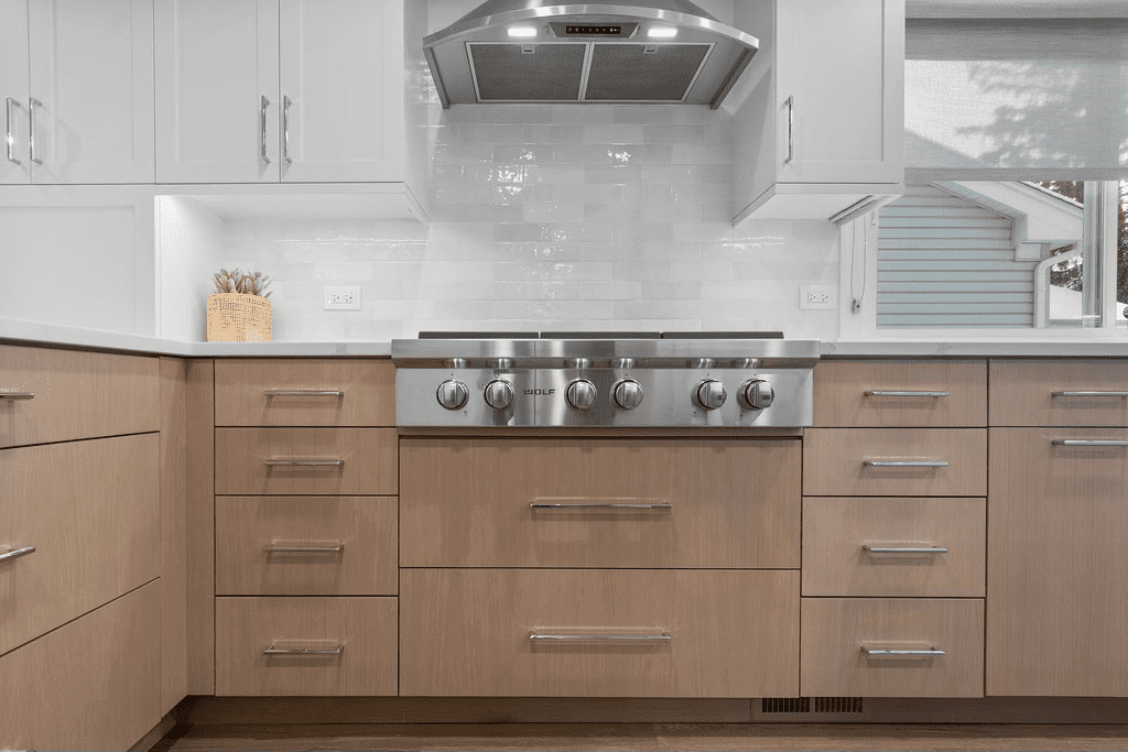 A kitchen with stainless steel appliances and wooden cabinets.