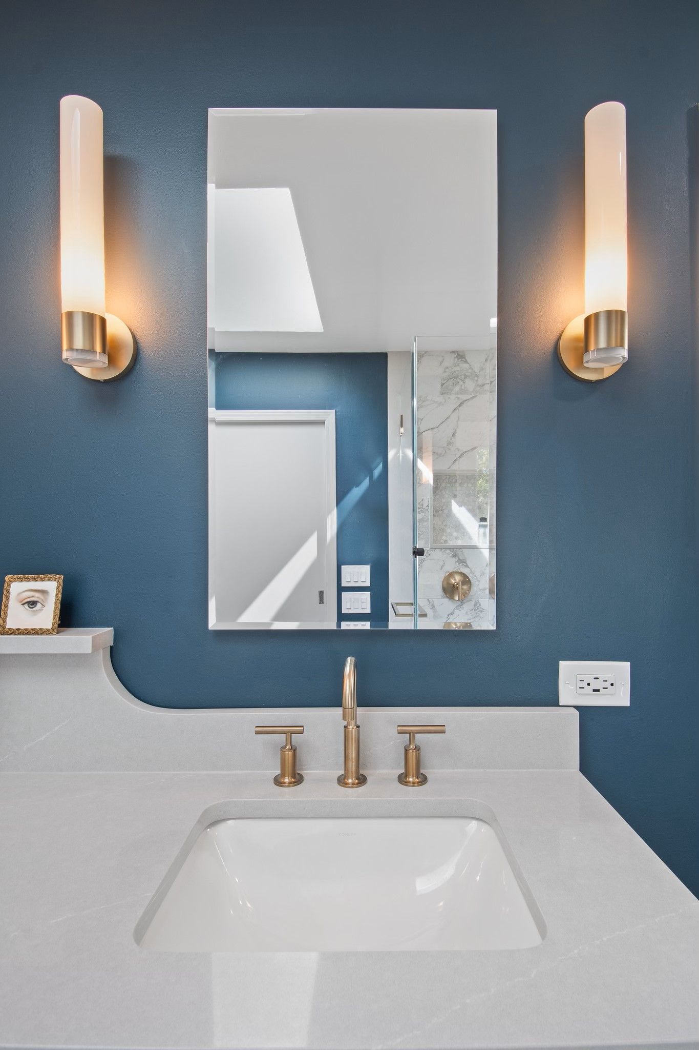 A bathroom with a sink and a mirror on the wall.