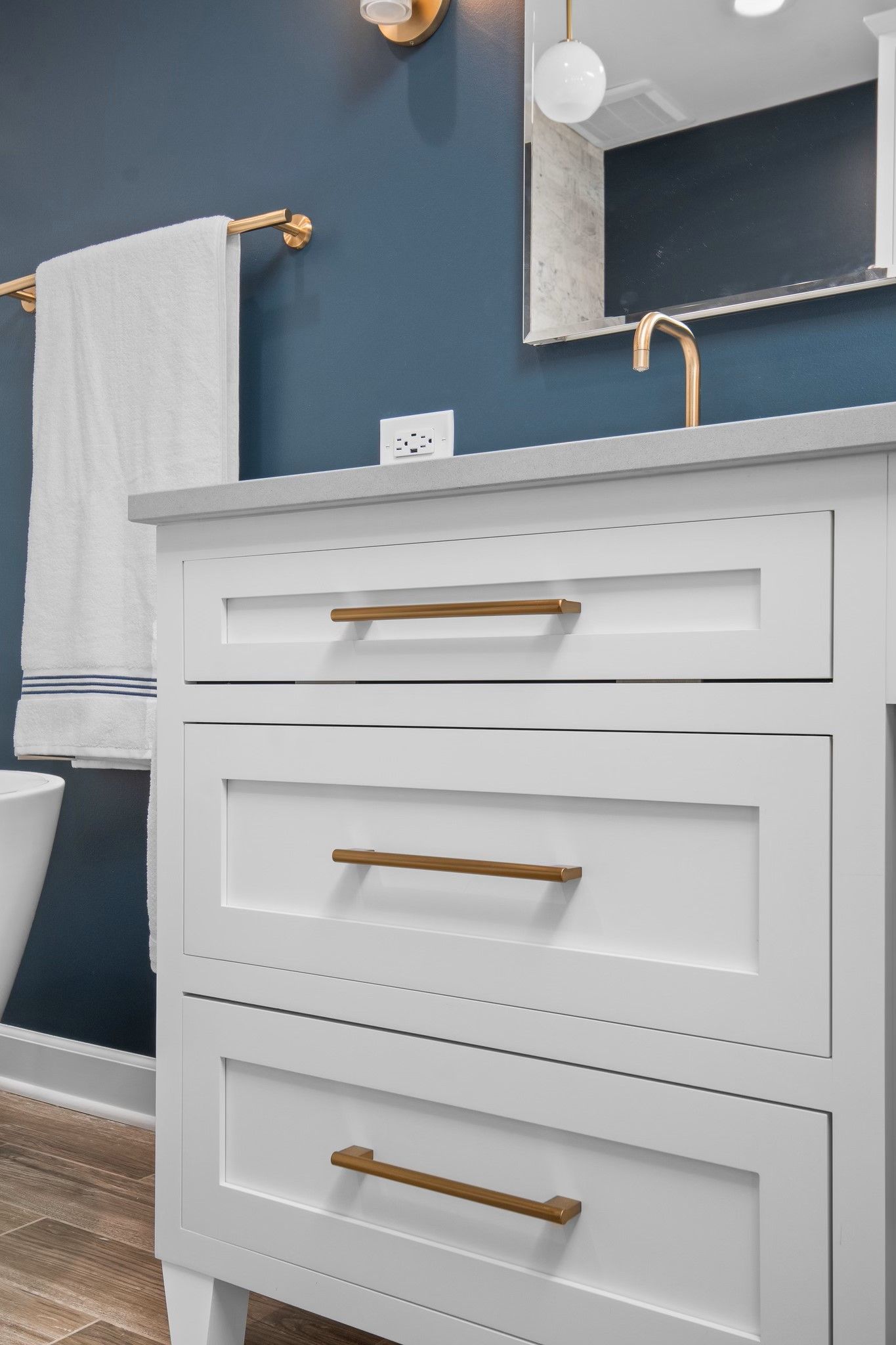 A bathroom with a sink , mirror , and toilet.