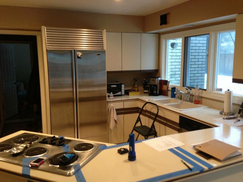 A kitchen with stainless steel appliances and white cabinets