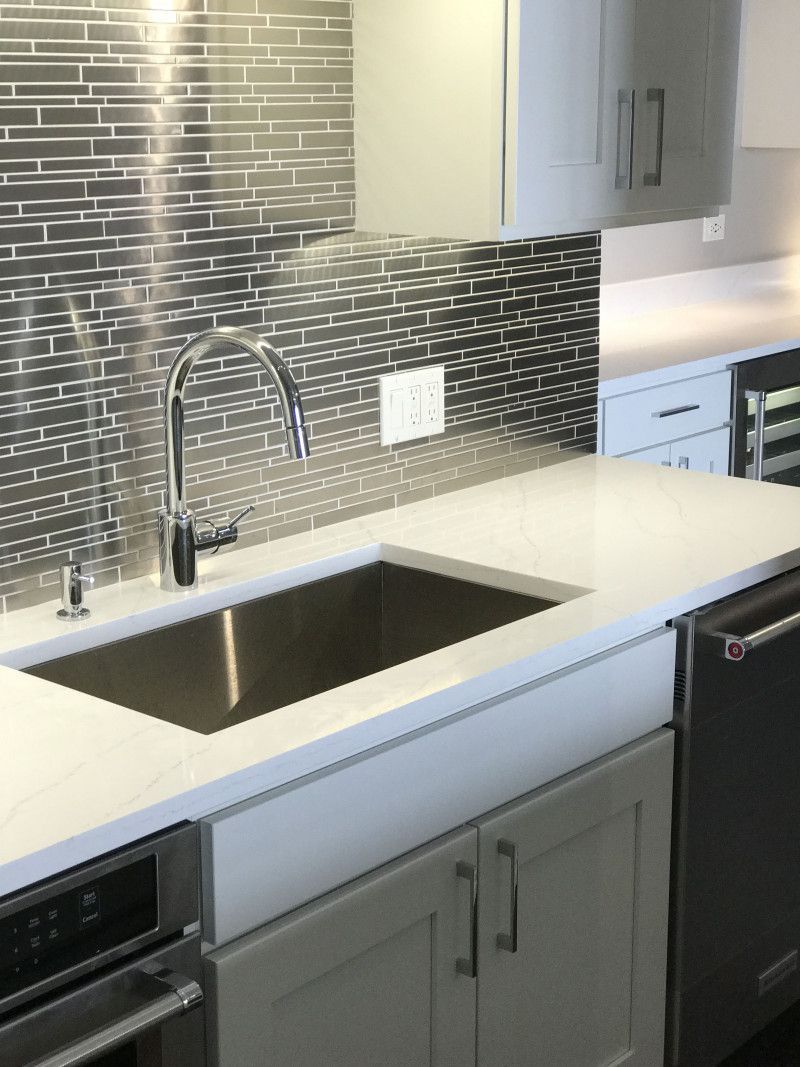 A kitchen with stainless steel appliances and a sink