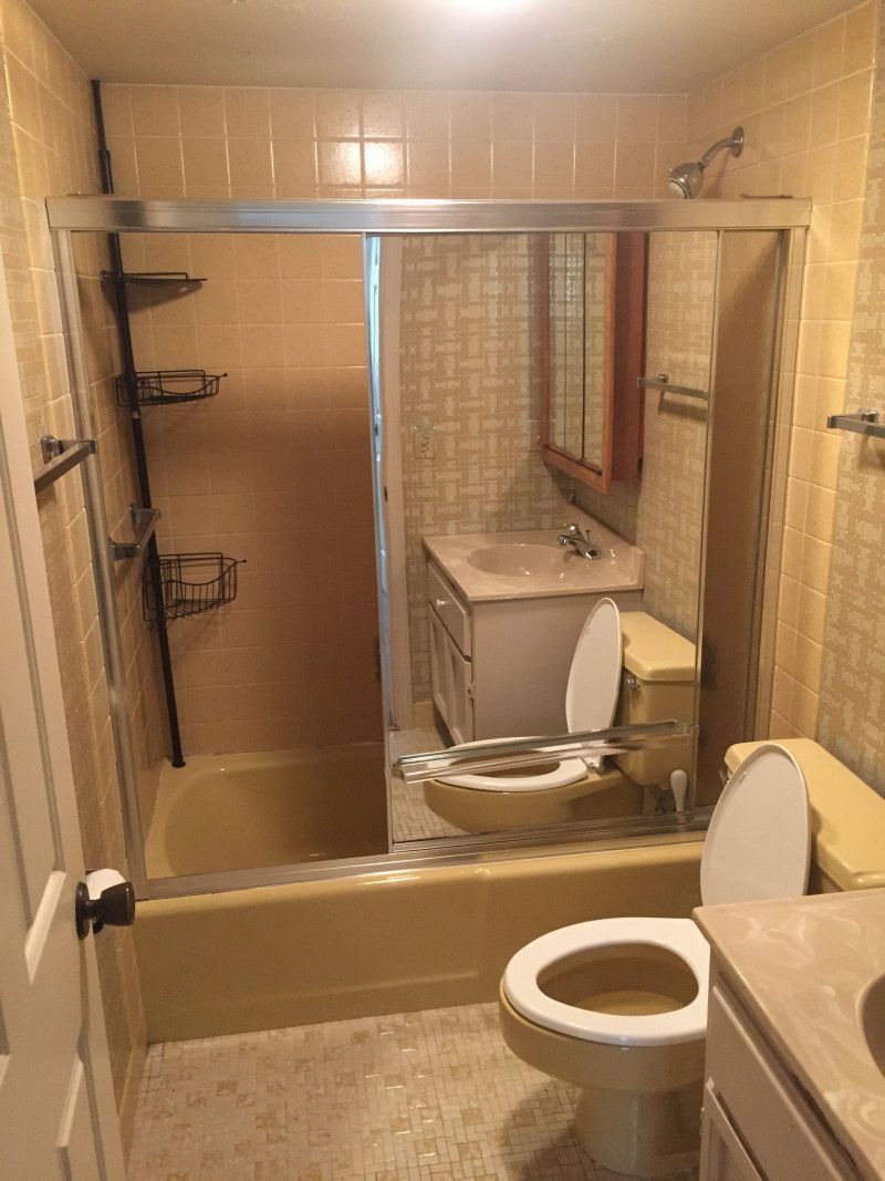 A bathroom with a toilet , sink , bathtub and shower.