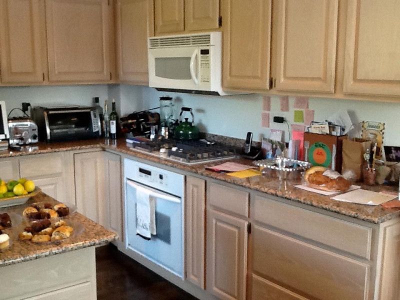A kitchen with wooden cabinets and granite counter tops
