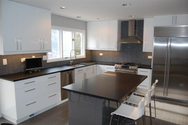 A kitchen with white cabinets and stainless steel appliances