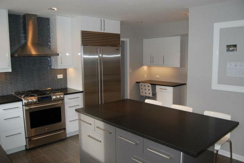 A kitchen with stainless steel appliances and white cabinets