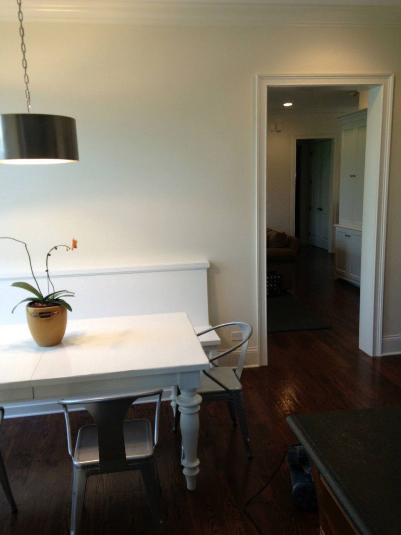 A dining room table with a potted plant on it
