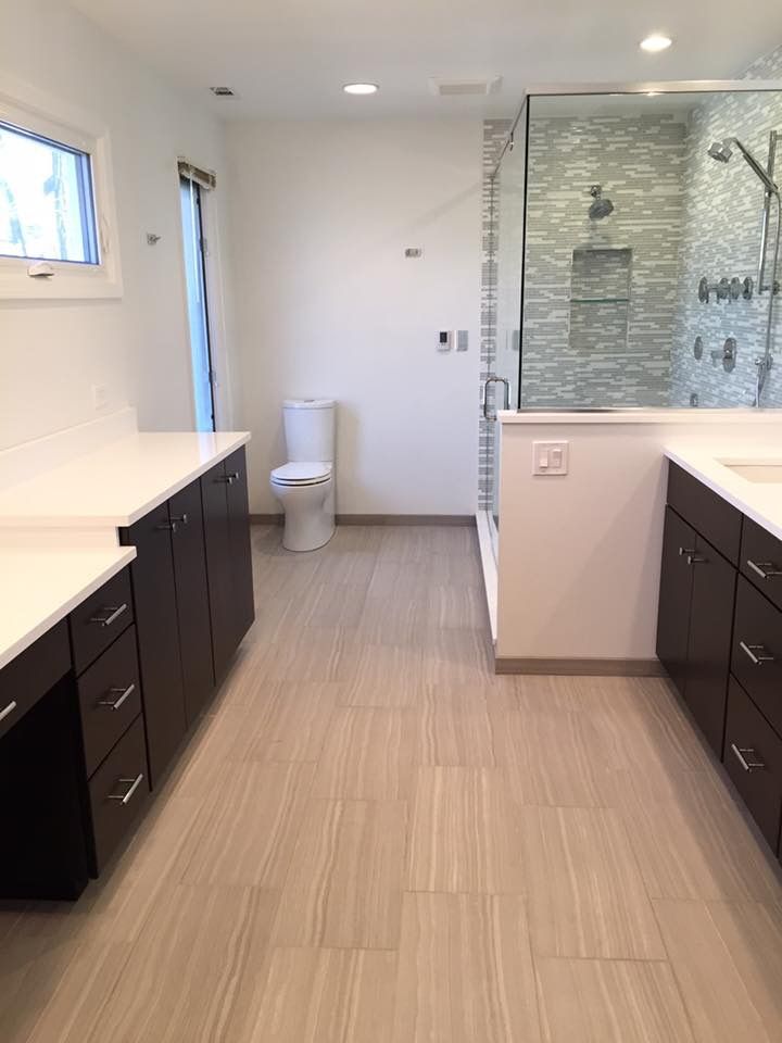 A bathroom with a toilet , sink , and shower.