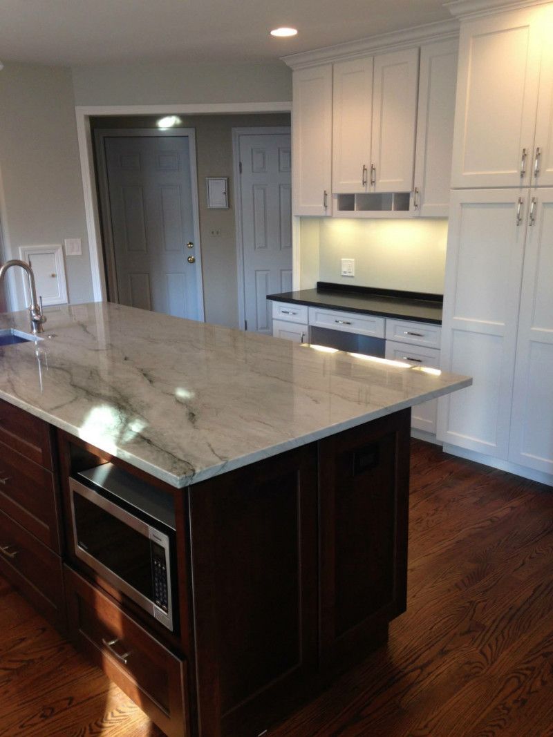 There is a large island in the middle of the kitchen.