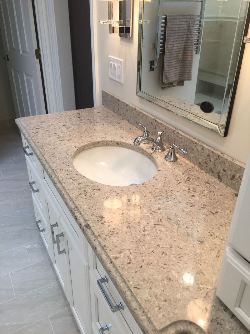A bathroom with a sink and a mirror on the wall.