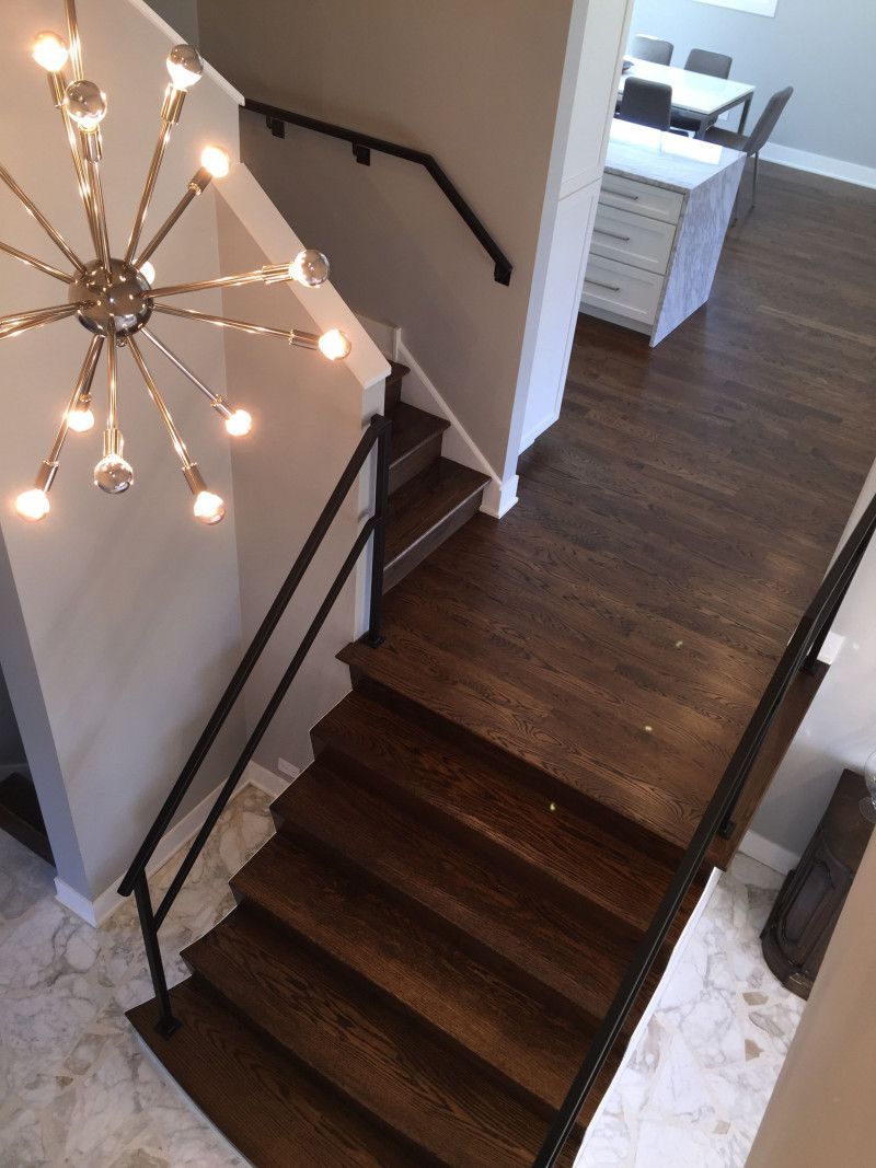 An aerial view of a staircase with a chandelier hanging from the ceiling