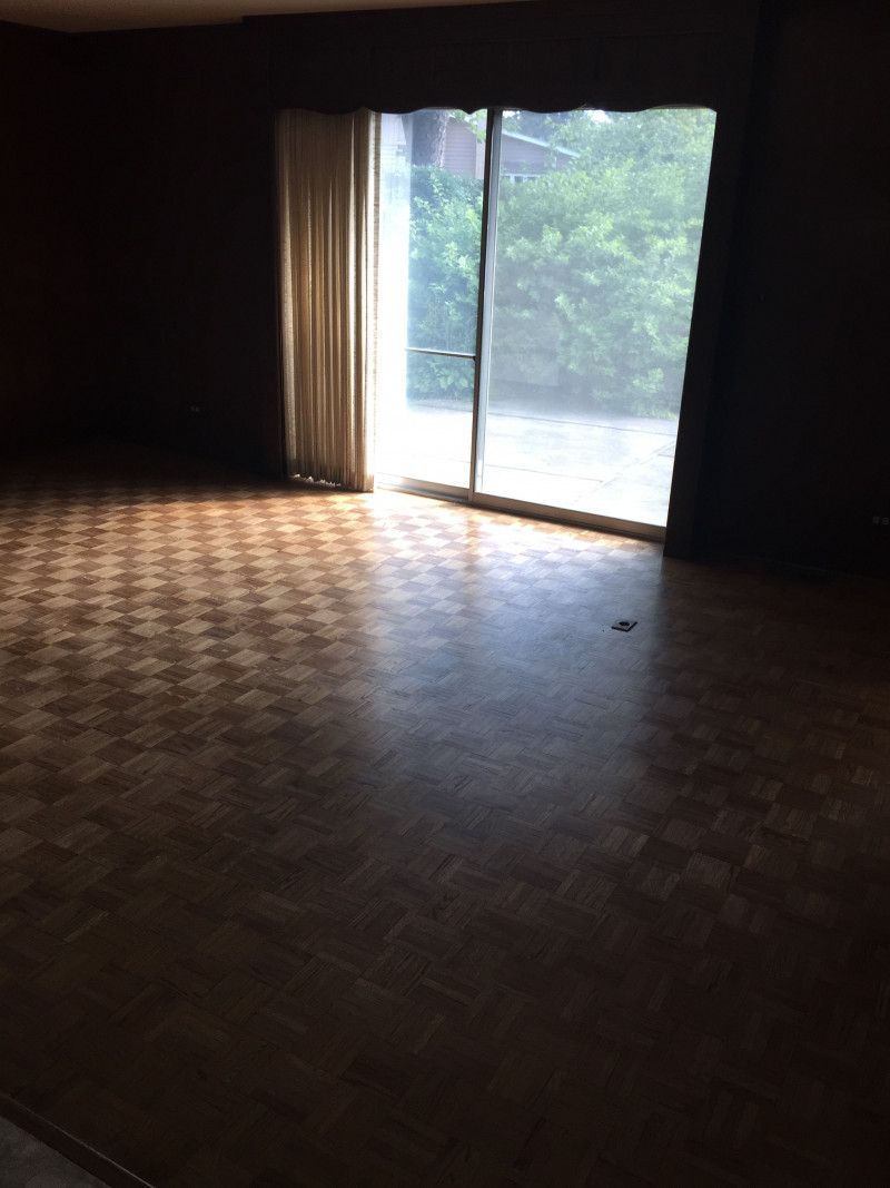 An empty living room with a sliding glass door