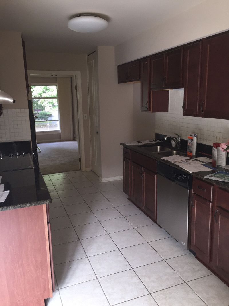 A kitchen with brown cabinets and stainless steel appliances
