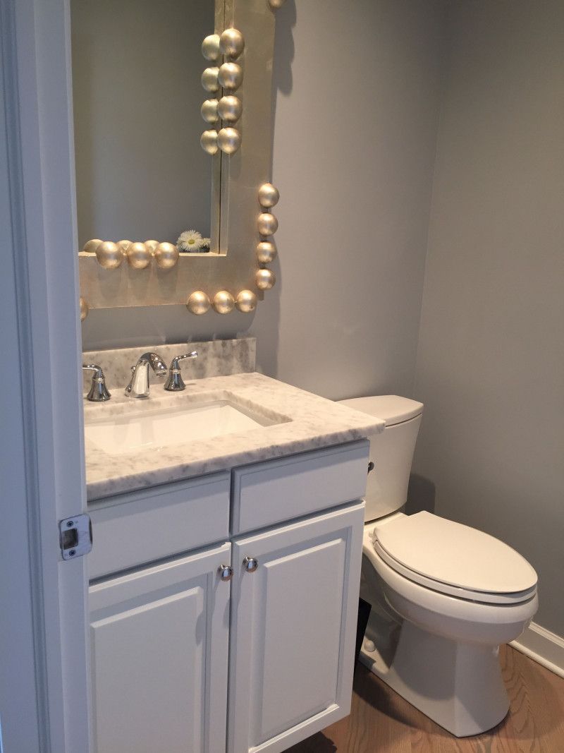 A bathroom with a sink , toilet and mirror