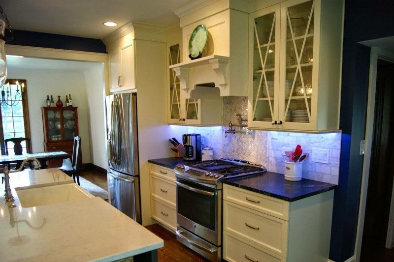 A kitchen with white cabinets and stainless steel appliances