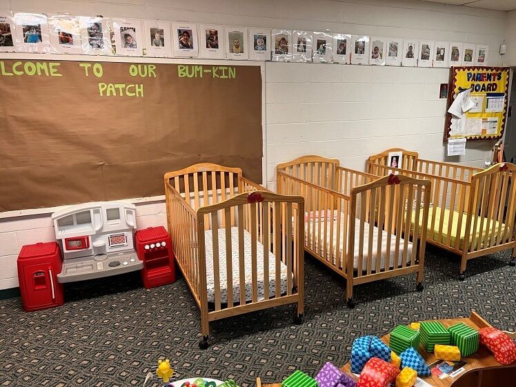A room with cribs and toys in it and a sign that says `` welcome to our patch ''.