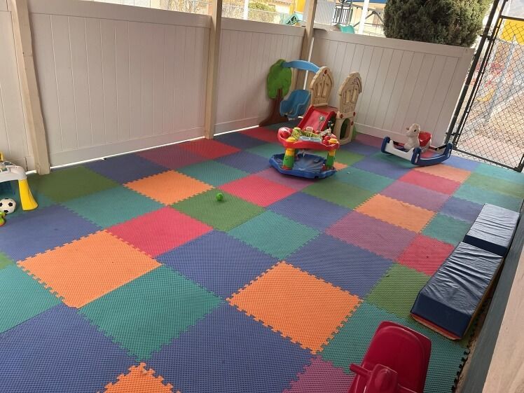 A colorful play area with toys on the floor.