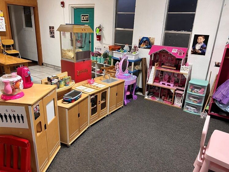 A room filled with lots of toys and a popcorn machine.