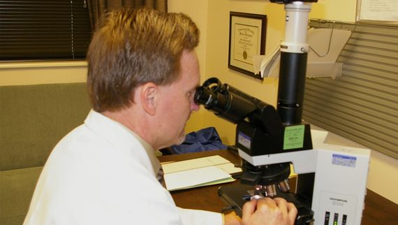 Doctor Looking Through Microscope - Anderson, SC - Anderson Skin & Cancer Clinic