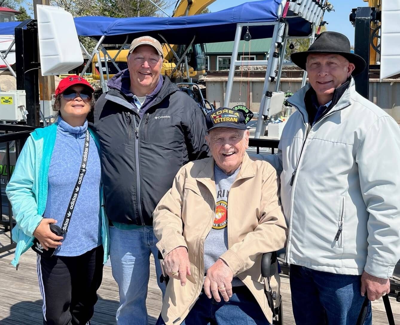 A group of people posing for a picture with one man in a wheelchair