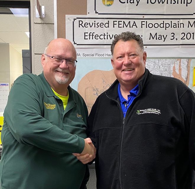 Clay Township Supervisor Artie Bryson and No Limits Fishing Adventures, Inc. President Blair Hughes shake on a deal to have No Limits Fishing Adventures, Inc. utilize the Pearl Beach Fishing Pier as the base of operations with a 5 year commitment.