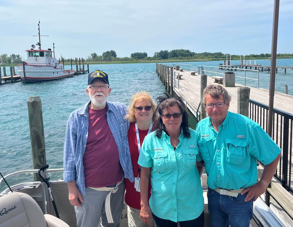 A group of people are posing for a picture on a boat.