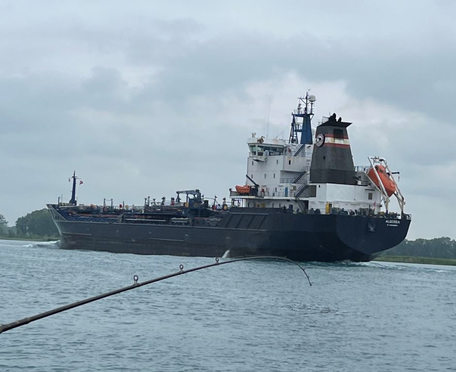 A large ship is floating on top of a body of water.
