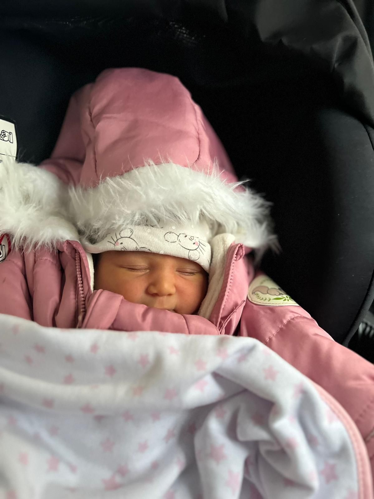 Baby girl in pink outfit
