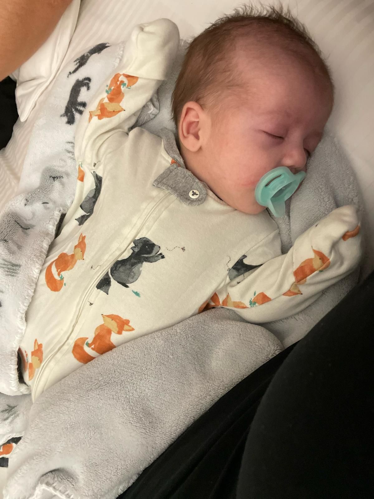 Peacefully sleeping newborn supported by Abilene Birth Doula