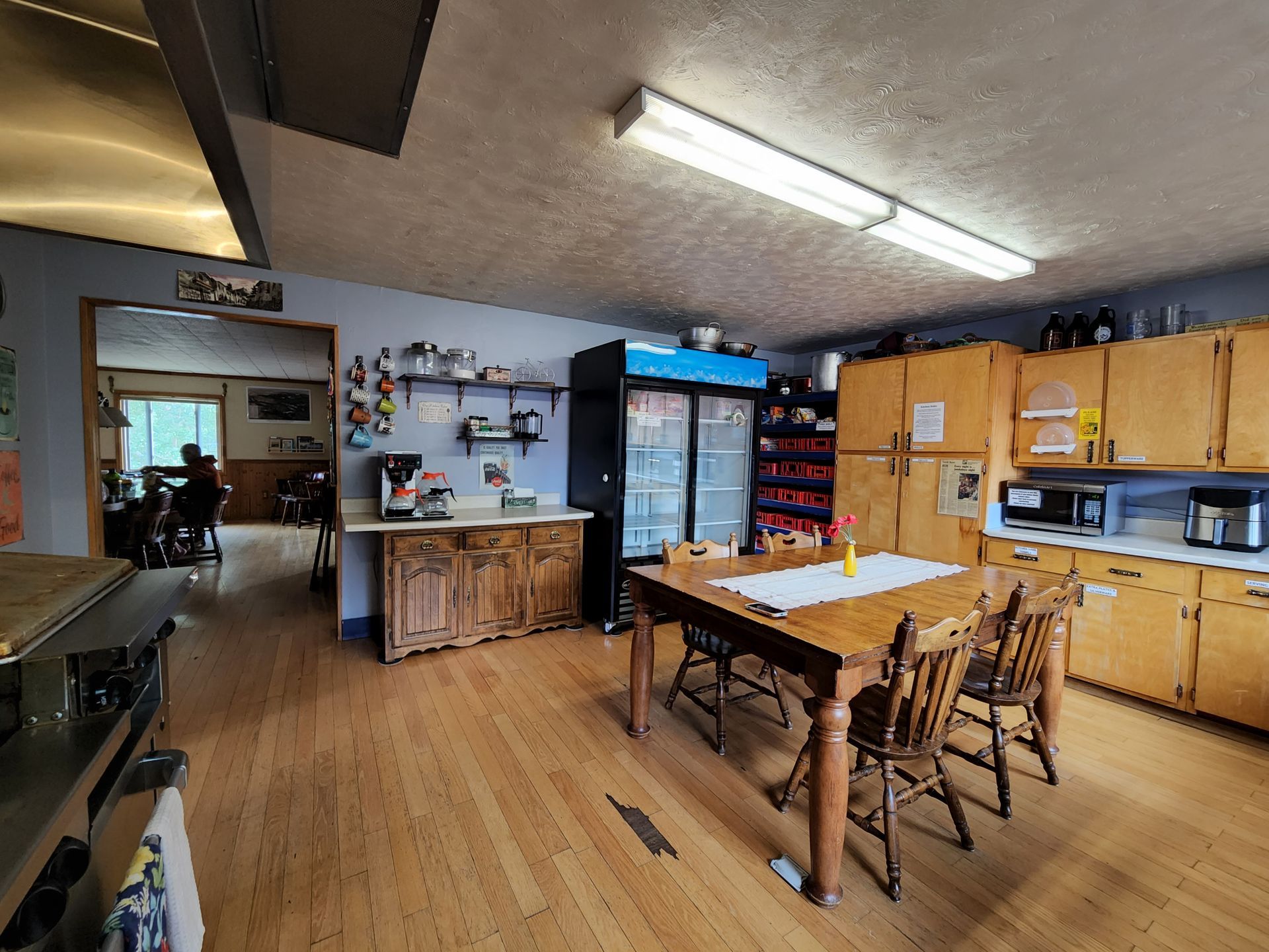 A kitchen with a table and chairs and a refrigerator.