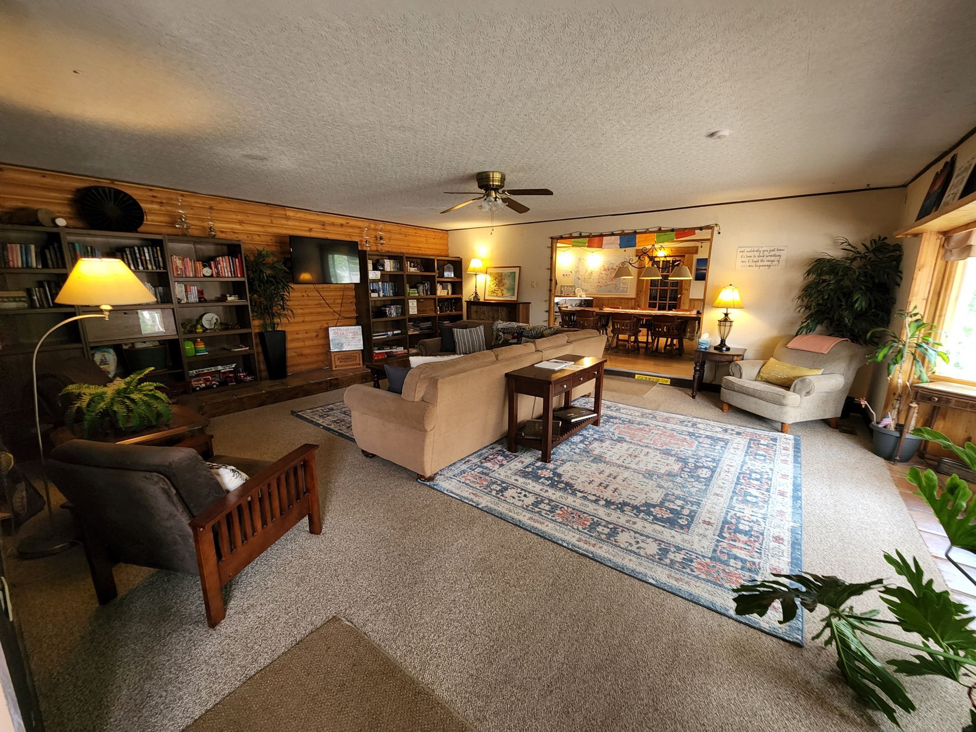 A living room filled with furniture and a ceiling fan