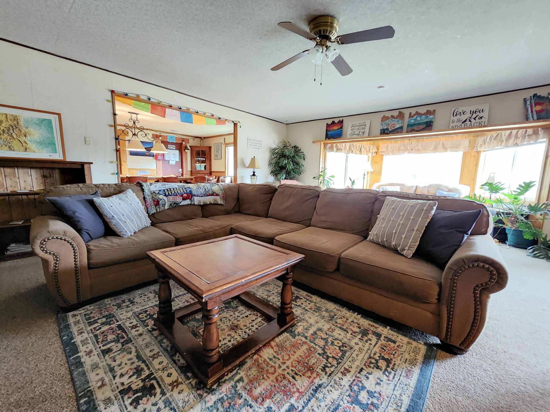 A living room with a large sectional couch and a coffee table.