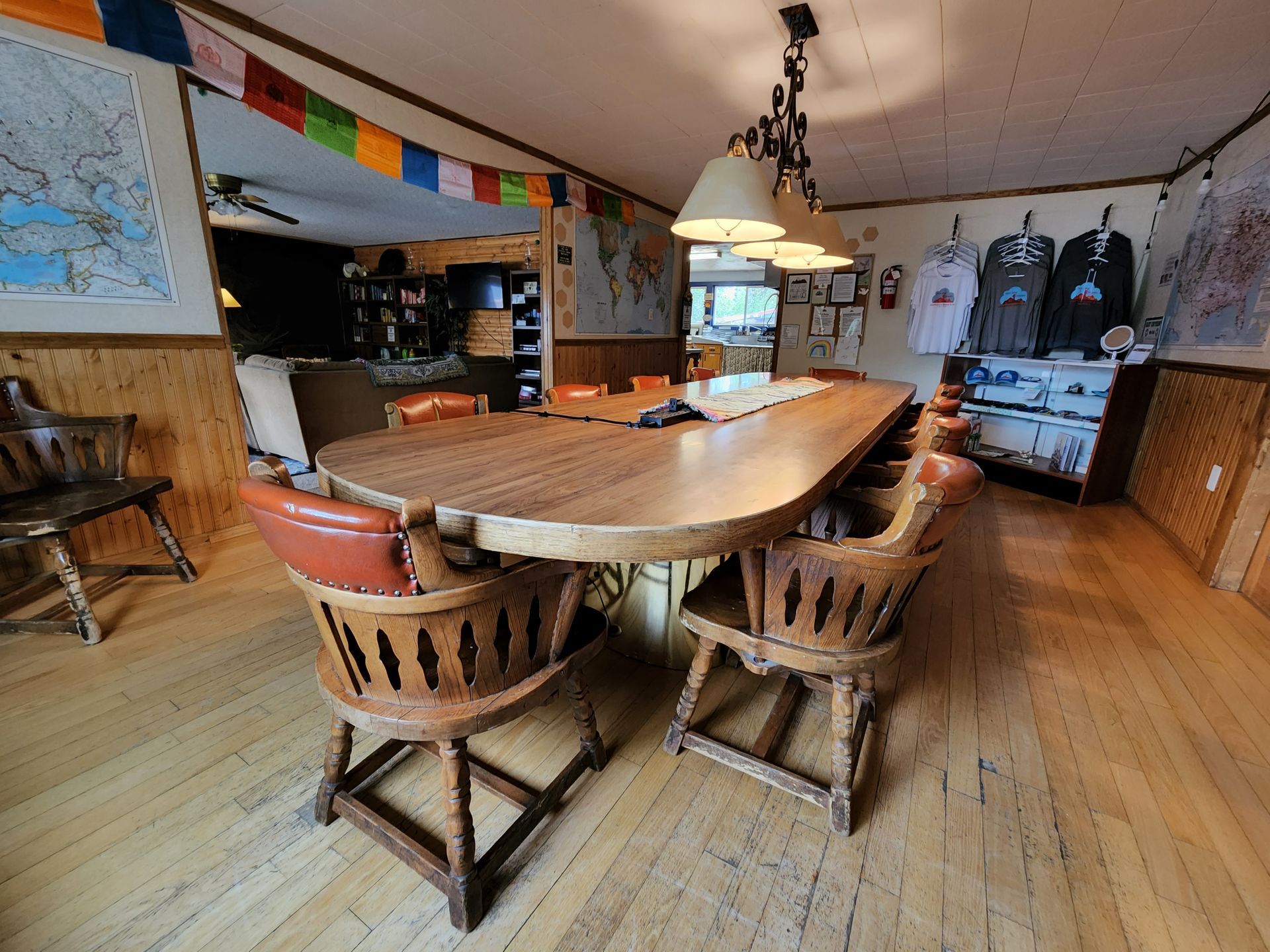 A dining room with a long wooden table and chairs