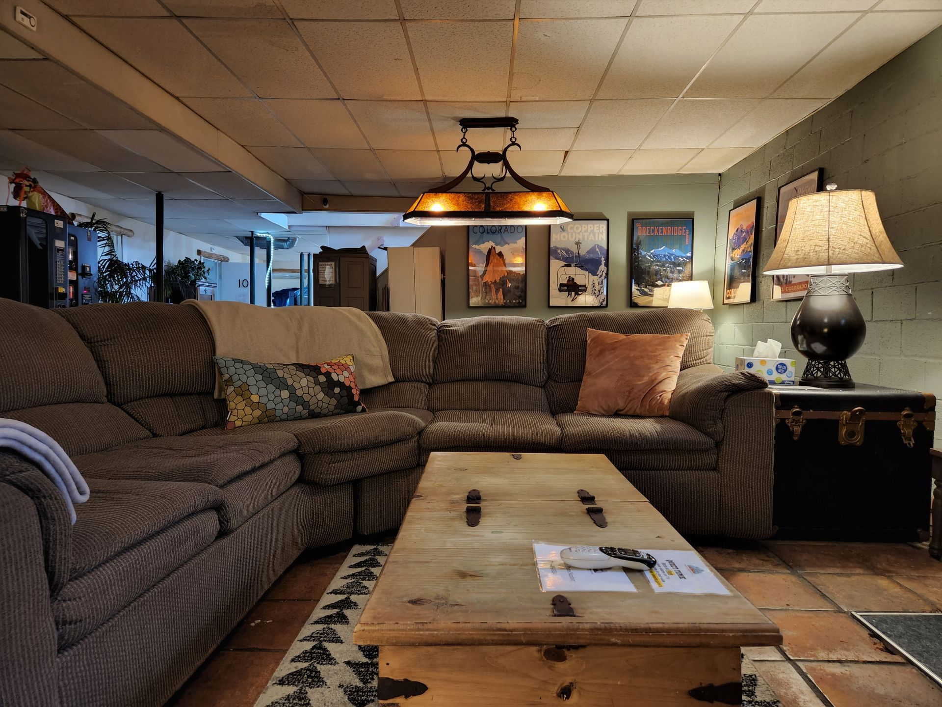 A living room with a large sectional couch and a wooden coffee table.