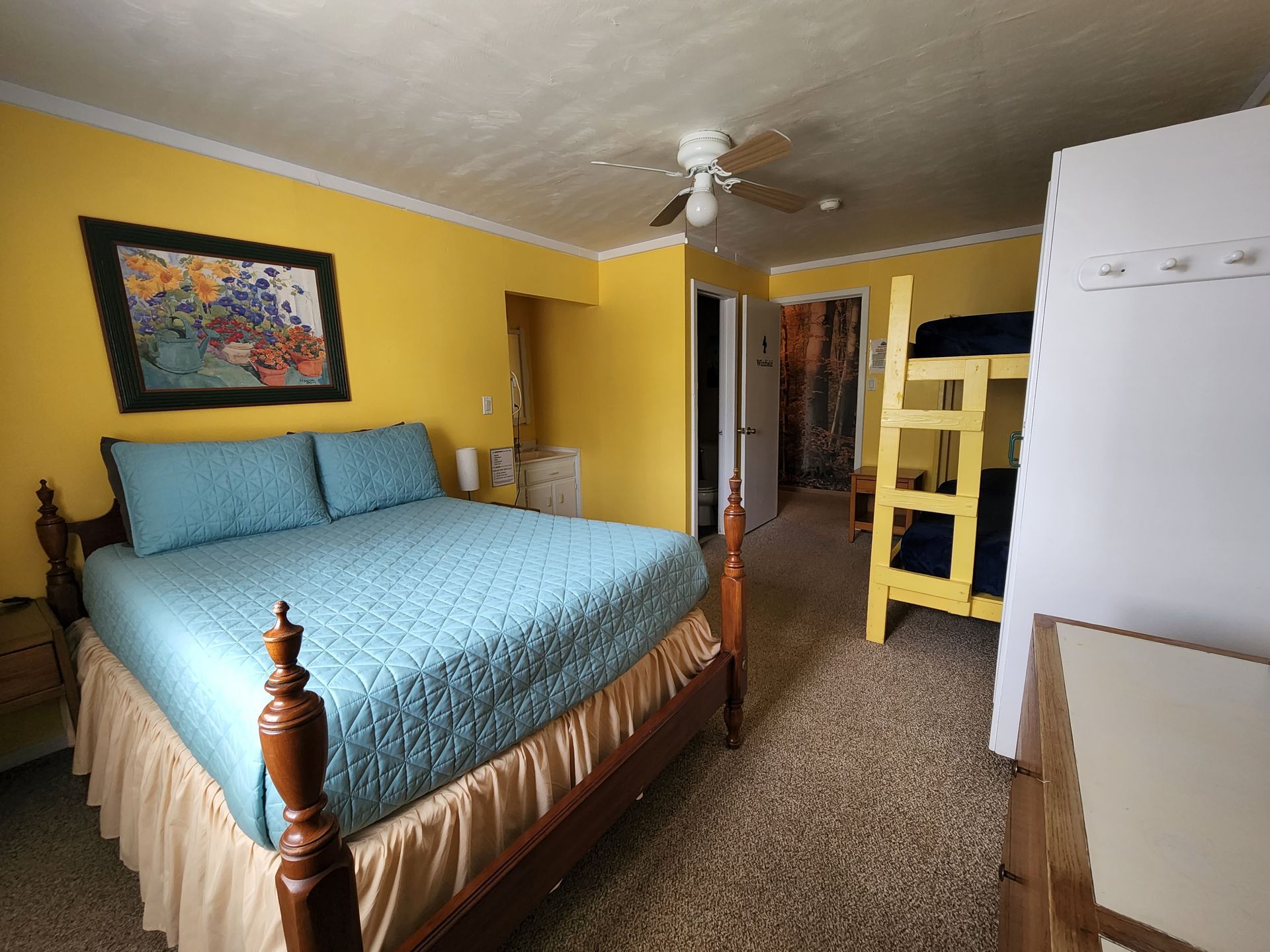 A bedroom with a king size bed and bunk beds