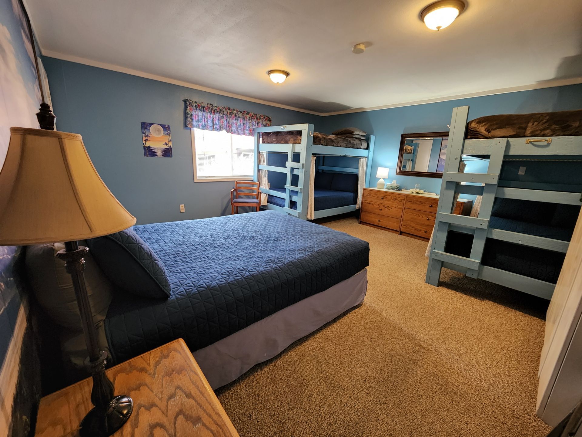 A bedroom with bunk beds and a large bed