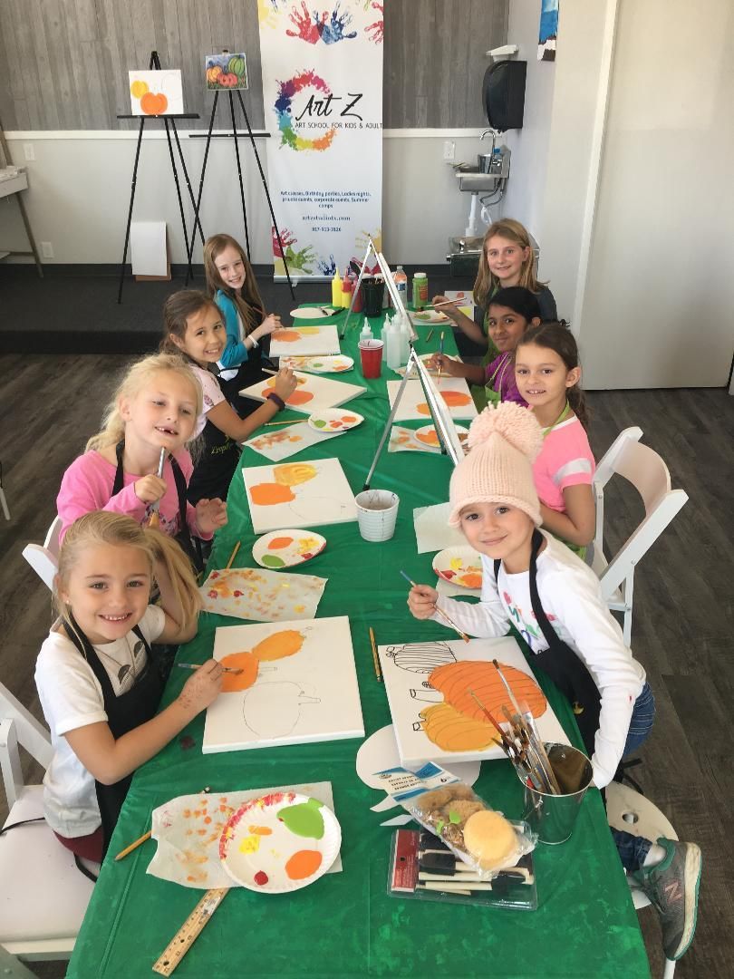 children painting at table during art class