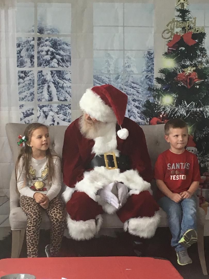 two children sitting by santa claus