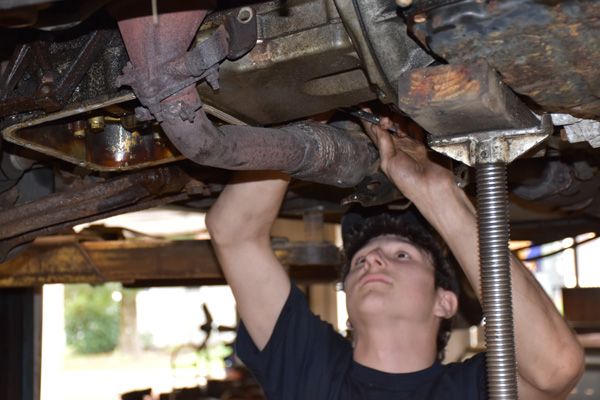 A mechanic repairing a vehicle | Laurel Hill Automotive & Tire