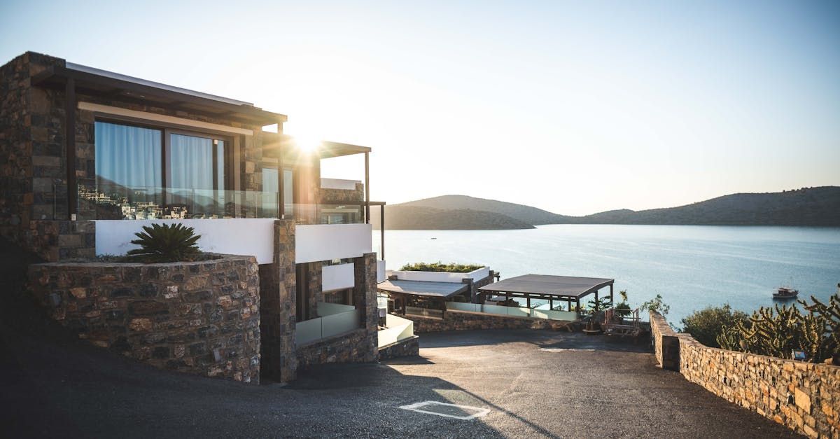 A large house with a view of the ocean and mountains.