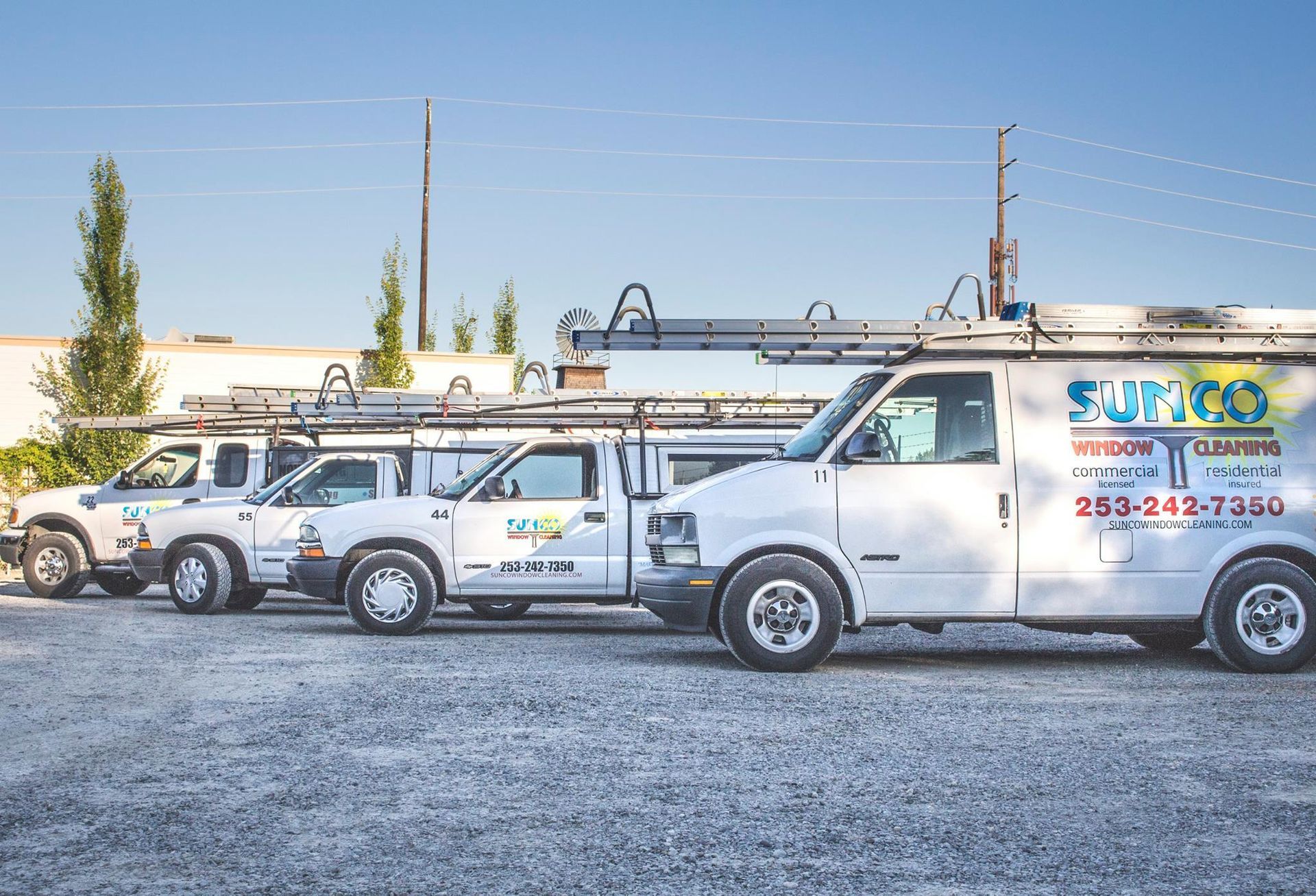 A group of men are standing in front of a white van.